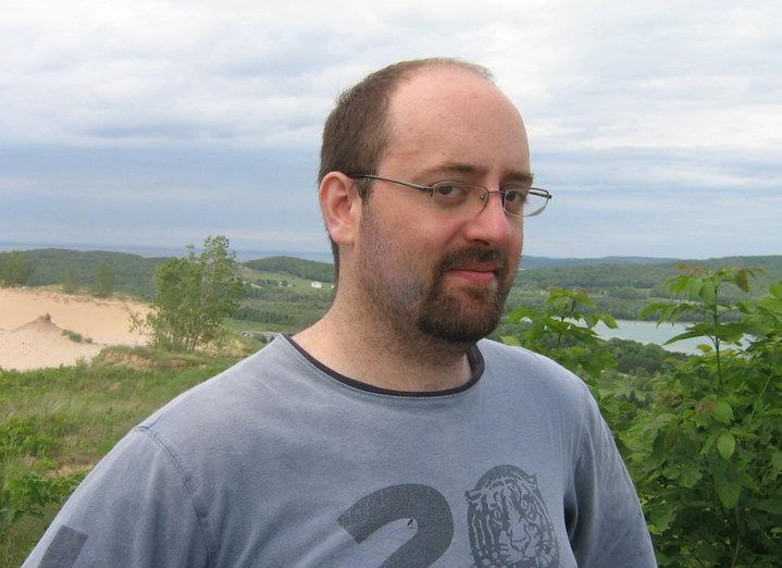 A photo of me standing before a panoramic view of a green valley, published to: "Poetry From the Working Class"